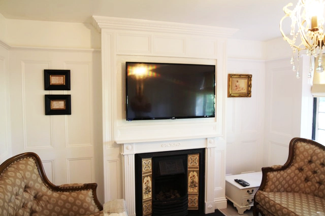 From Clutter to Class: A TV Mirror Transformation 7 White living room interior decor with a TV before installing the Mirror TV Frame over it.